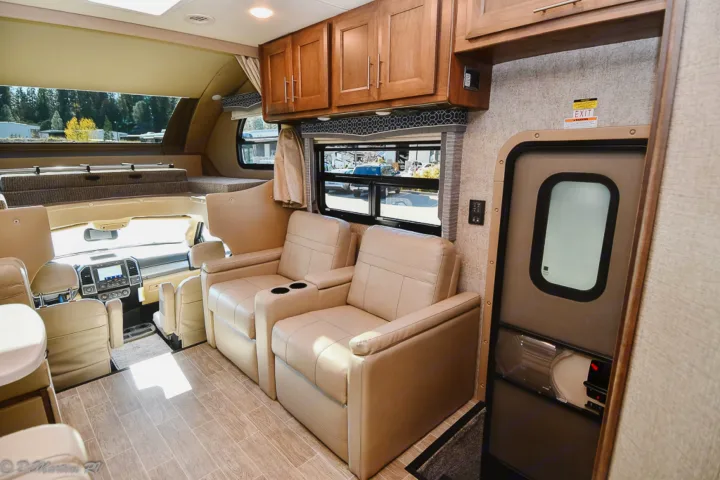 RV rental interior showing a comfortable living space with recliners, an overhead bunk, and the front cockpit.. Thor Motor Coach Other 2021