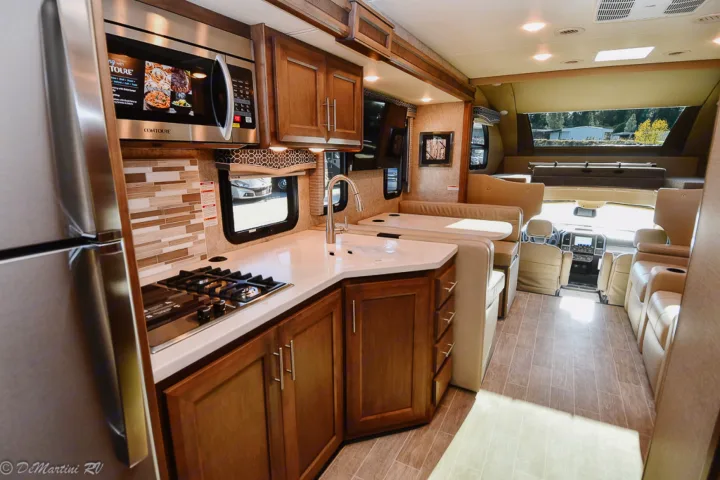 Explore this modern **rv rental** interior, showcasing a fully equipped kitchen, comfortable seating, and a spacious layout.. Thor Motor Coach Other 2021