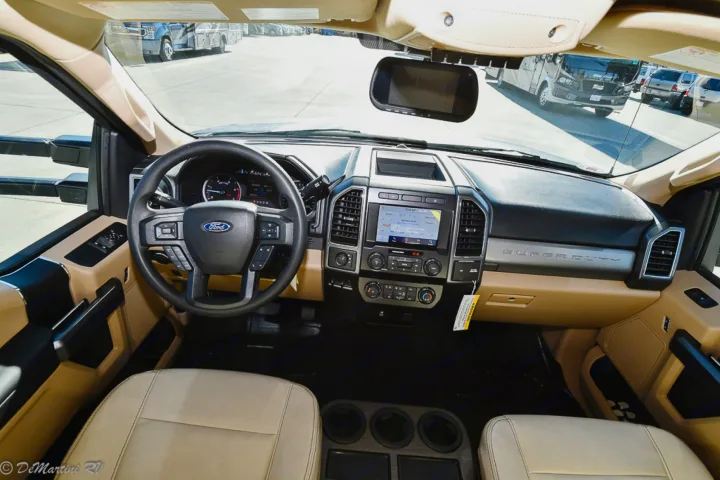 Spacious Ford Super Duty interior of an RV rental, showing the dashboard, steering wheel, and infotainment screen.. Thor Motor Coach Other 2021