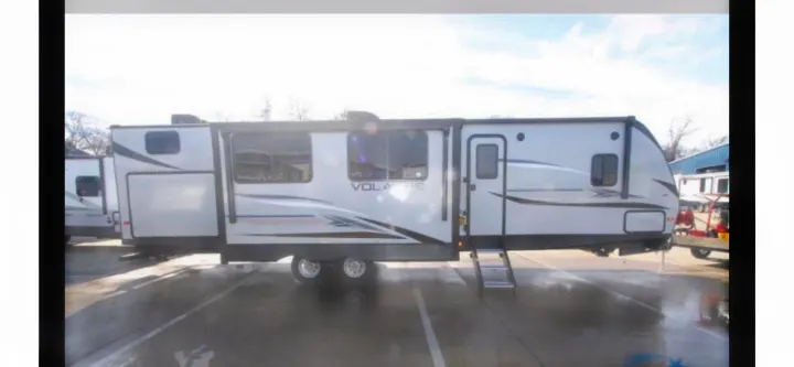 Modern white travel trailer, great for rv rental. Features extended slide-outs and easy entry steps.. crossroads Volante 2020