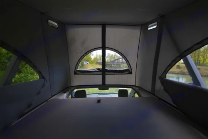 Inside a vehicle pop-top tent, a sleeping platform offers scenic views.. Volkswagen California Coast T6.1 DSG7 2023