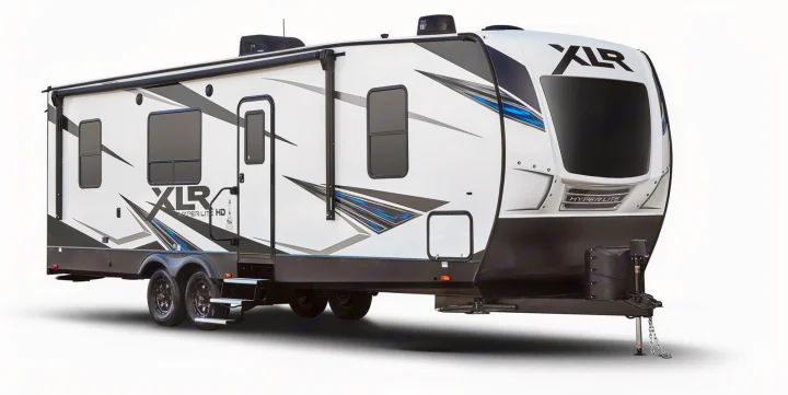 A white XLR Hyper Lite HD travel trailer/RV with black/blue graphics, an awning, and dual axles, perfect for an RV rental.. Forest River XLR HYPERLITE 2815 2021