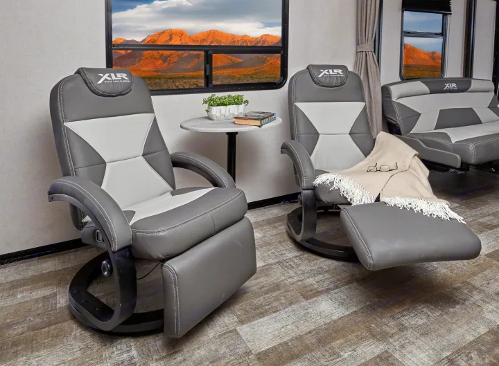 Comfortable RV rental interior: XLR reclining chairs, sofa, and a stunning mountain view.. Forest River XLR HYPERLITE 2815 2021