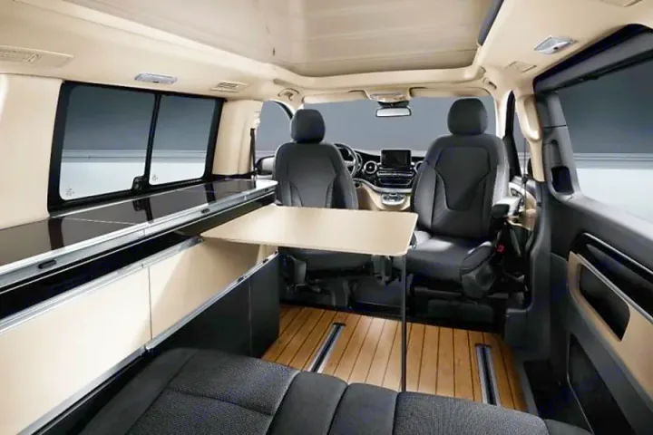 Inside this modern RV rental camper, a flexible living space with a table, modular seating, and sleek storage awaits adventure.. Mercedes Marco Polo Class V 250d 2022