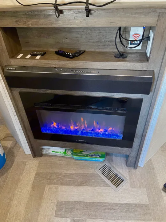 An RV rental's built-in entertainment hub: electric fireplace, Furrion soundbar, Wi-Fi ready.. Forest River Salem 2020