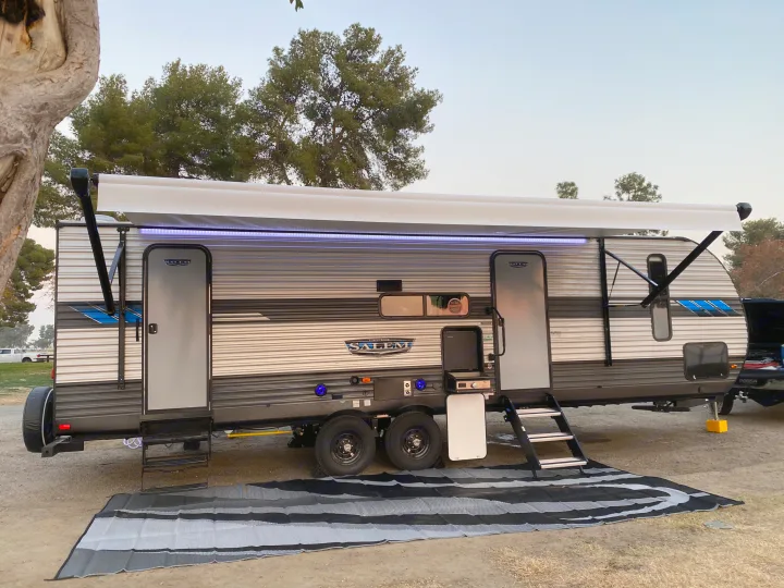 This RV rental, with its extended awning and outdoor kitchen, is set up for a relaxing outdoor adventure.. Forest River Salem 2021