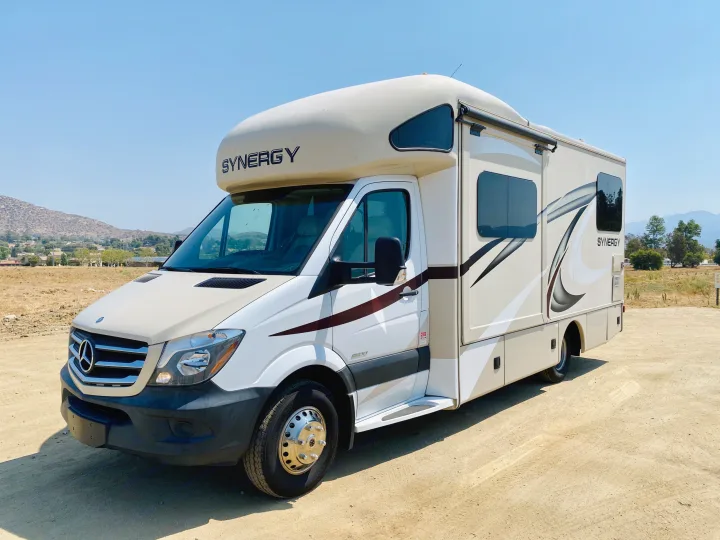 This white & tan Mercedes-Benz Synergy RV rental, a compact motorhome, is ready for adventure on a sunny day.. Thor Motor Coach Other 2016