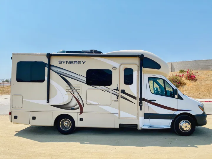 Light-colored Thor Synergy rv rental (motorhome) parked outdoors on a bright, clear day.. Thor Motor Coach Other 2016