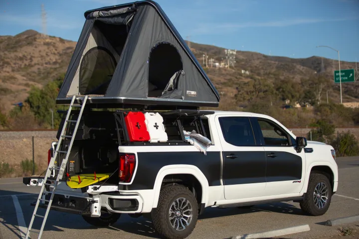 Explore with this RV rental! A GMC AT4 pickup features a rooftop tent, ladder, and gear for your next overlanding adventure.. Other Other 2021