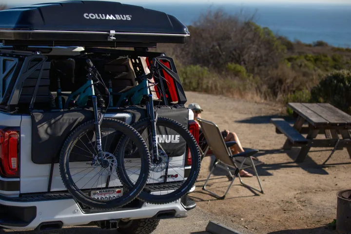 RV rental alternative: Truck with tent & bikes by the ocean, person relaxing.. Other Other 2021