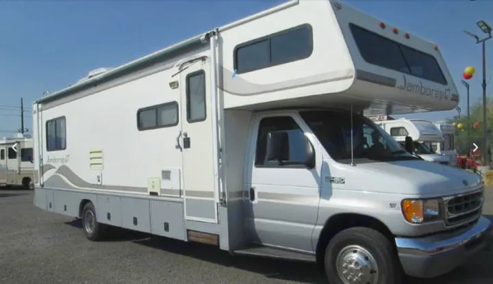 White & grey Jamboree Class C motorhome, a versatile rv rental option with a Ford E-350 chassis, ready for trips.. Fleetwood Jamboree Sport 1999