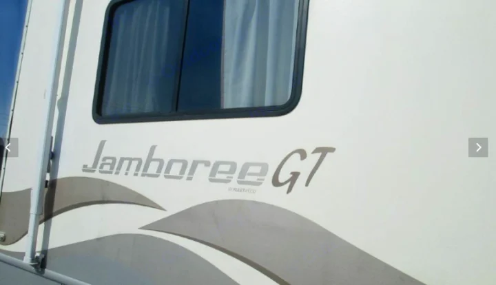 White Jamboree GT Fleetwood motorhome side with window and graphics, ready for your next rv rental.. Fleetwood Jamboree Sport 1999