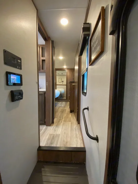 spacious bedroom, hall and bathroom leading to a huge kitchen and living area with fireplace and large tv. Durango Durango Fifth Wheel 2021
