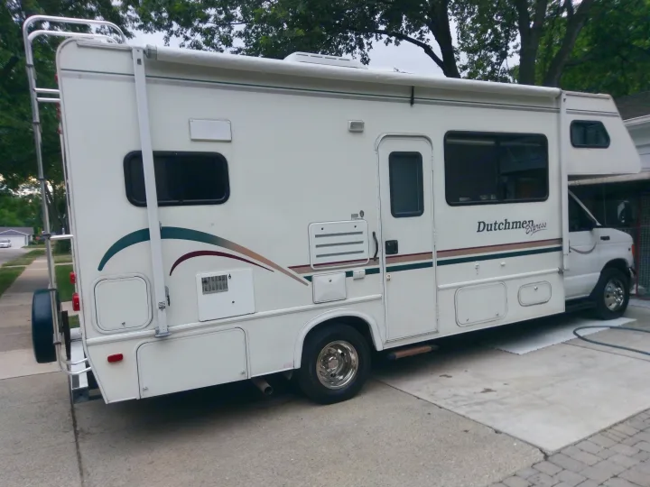 White Class C RV rental, a Dutchmen Express motorhome, parked on a driveway for your next adventure.. Dutchmen Other 2001