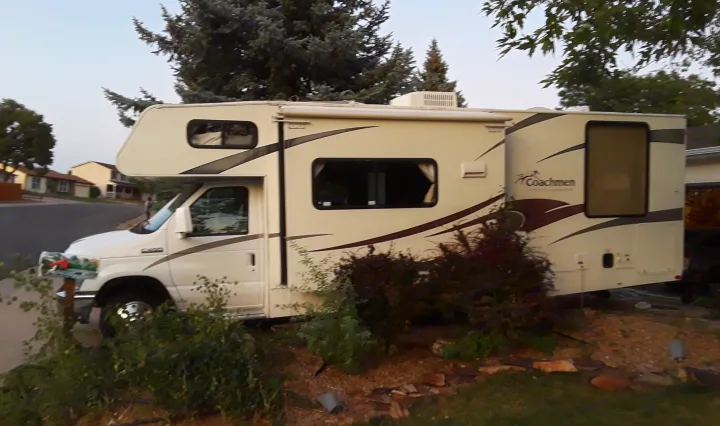A white Coachmen Freelander Class C RV parked in a residential. Coachmen Freelander 2011