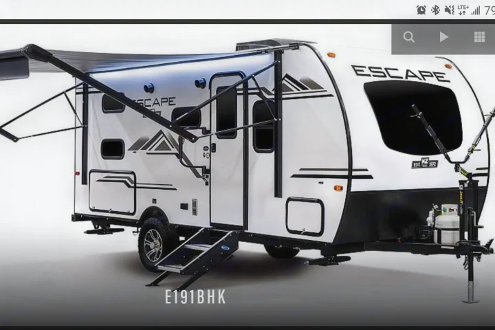 White Escape travel trailer RV (model E191BHK) with an extended awning, steps, and black trim. Ideal for an RV rental.. K-Z Manufacturing Escape 2021