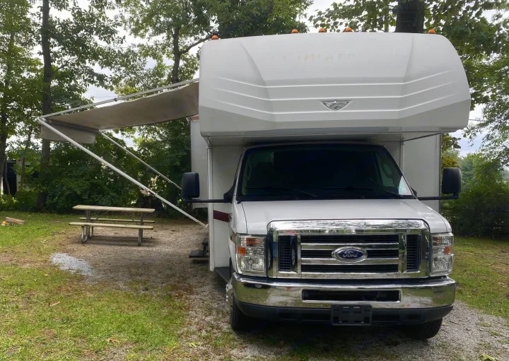 Slides and the awning are shown in the open position.. Fleetwood Jamboree Sport 2014