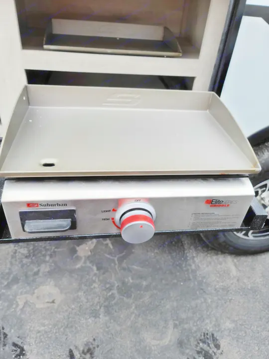 RV rental outdoor kitchen featuring a Suburban Elite Series griddle with lighting instructions.. K-Z Manufacturing Escape 2021