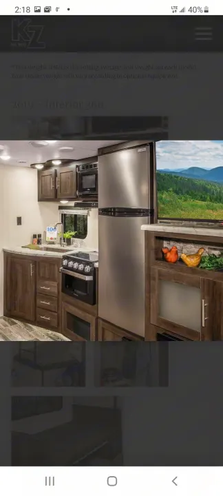 Modern RV rental interior with a fully equipped kitchen, including fridge, stove, and microwave. Ideal for your next trip.. Other Sportsmen 2019