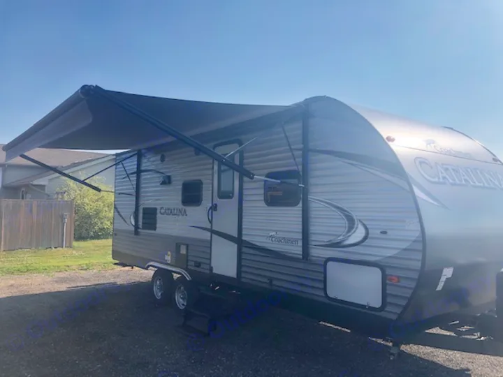 Our gray Coachmen Catalina travel trailer, with awning extended, is ready for your next rv rental getaway under clear skies!. Catalina 221TBS 2018
