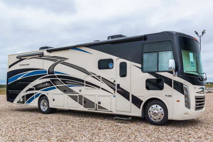 Modern Thor Hurricane motorhome, an impressive rv rental option, featuring a distinctive black, beige, and blue exterior.. Thor Motor Coach Hurricane 2021