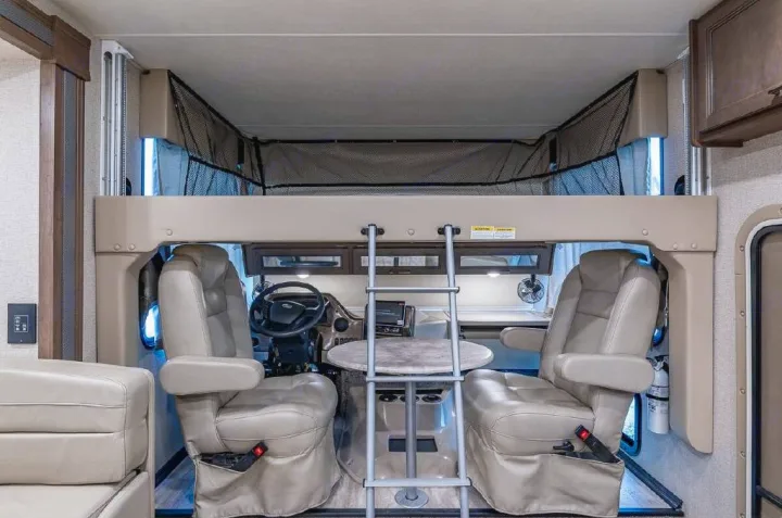 RV rental: Step into this motorhome's cockpit with swiveling seats, a dining table, and an over-cab bunk bed with safety net.. Thor Motor Coach Hurricane 2021