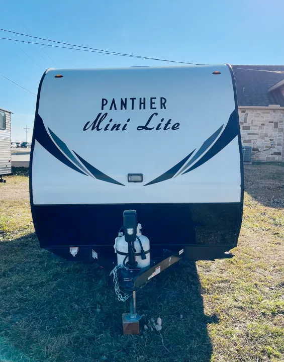 Front view of a white Panther Mini Lite travel trailer, ideal for your next RV rental adventure.. Pacific Coachworks Panther 2019
