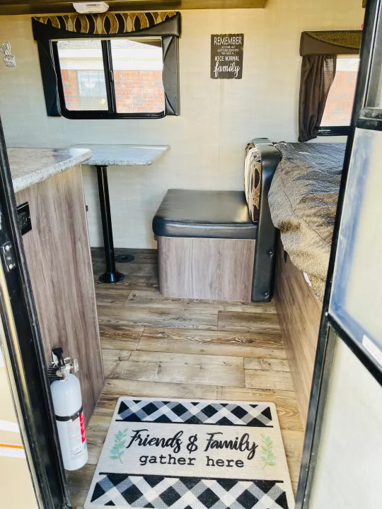 RV rental: Cozy interior featuring a dinette, bed area, light wood-look flooring, and homey decor.. Pacific Coachworks Panther 2019