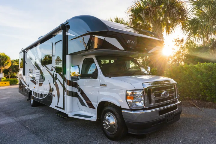 This RV rental, an Esteem Entegra motorhome, is ready for your next outdoor adventure under a beautiful sunset.. Entegra Coach Esteem 31F 2021