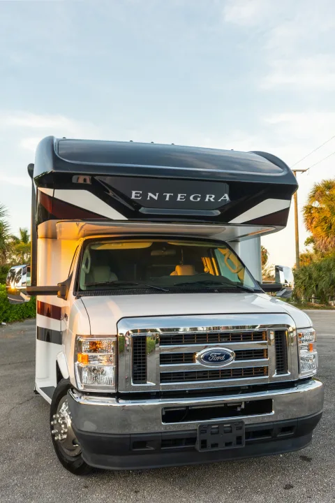 Front view of a sleek white and black Entegra Class C rv rental, a perfect motorhome for your next road trip.. Entegra Coach Esteem 31F 2021