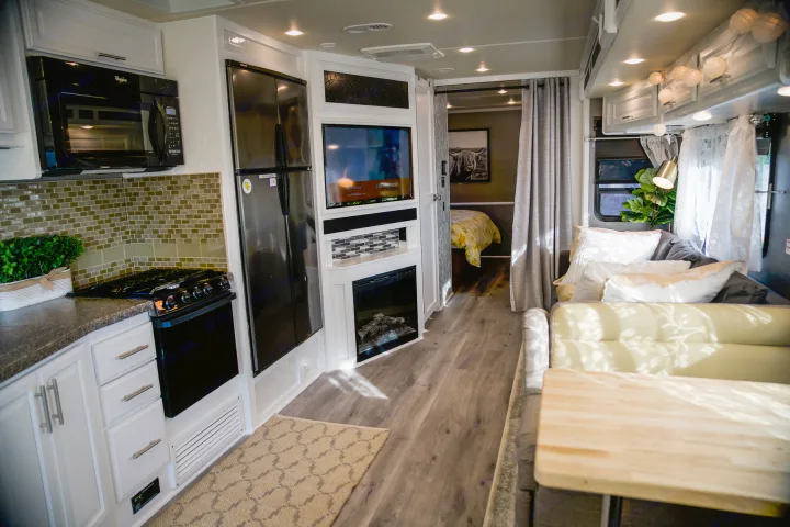 Bright, modern rv rental interior with full kitchen, comfortable living area, and private bedroom.. Fleetwood Bounder 2015