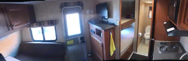 Looking out, our tv, radio, cd player, and storage. Thermostat on wall . Jayco Camper Trailer- Swift 2012