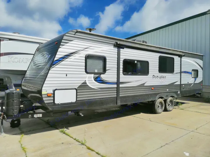 This Prowler Lynx travel trailer is ready for an RV rental adventure, parked outdoors on a sunny day.. Heartland Prowler Lynx 2018