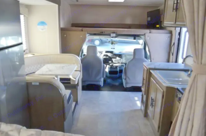 Spacious RV rental interior with dinette, kitchen, cockpit, and overhead bunk, perfect for travel.. Coachmen Freelander 2022