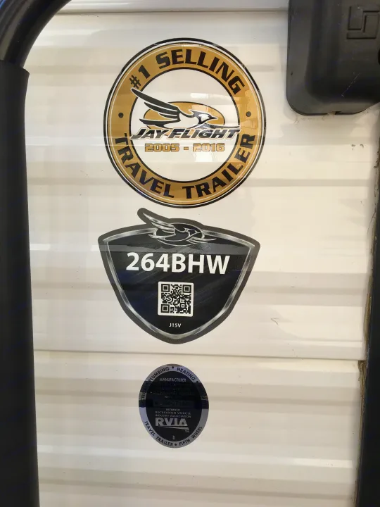 Side of a Jay Flight travel trailer, model 264BHW, with #1 selling and RVIA compliance decals. Ideal for rv rental.. Jayco Jay Flight 2018