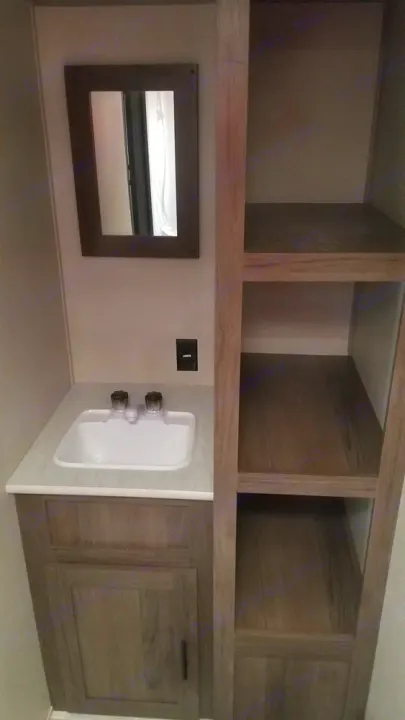 RV rental interior: small bathroom vanity with sink, mirror, and handy open shelving.. Prime Time Avenger 16FQ 2021
