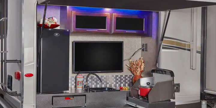 This RV rental features a full outdoor kitchen: fridge, TV, sink, and pull-out stove, perfect for open-air cooking.. Jayco Eagle HT 2018