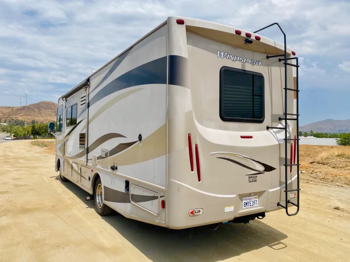 This RV rental, a Windsport motorhome, is parked on dirt, ready for California adventures.. Thor Motor Coach Windsport 2014