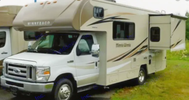 This beige & white Winnebago Minnie Winnie Class C RV, with its slide-out extended, is ready for your next rv rental.. Winnebago Minnie Winnie 22M 2022