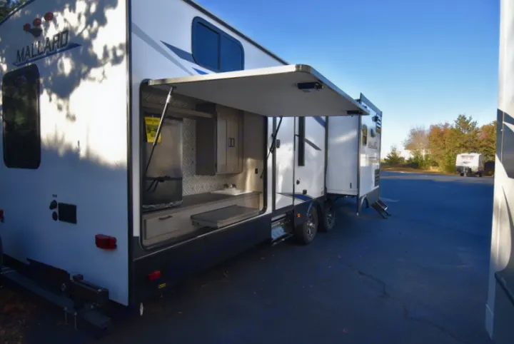 This rv rental boasts an outdoor kitchen with a sink, counter, and fridge, perfect for your next camping adventure.. Other M-3385 2020