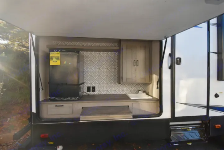 Outdoor kitchen setup on an RV rental: includes fridge, sink, cabinets, and patterned backsplash. Perfect for al fresco cooking.. Other M-3385 2020