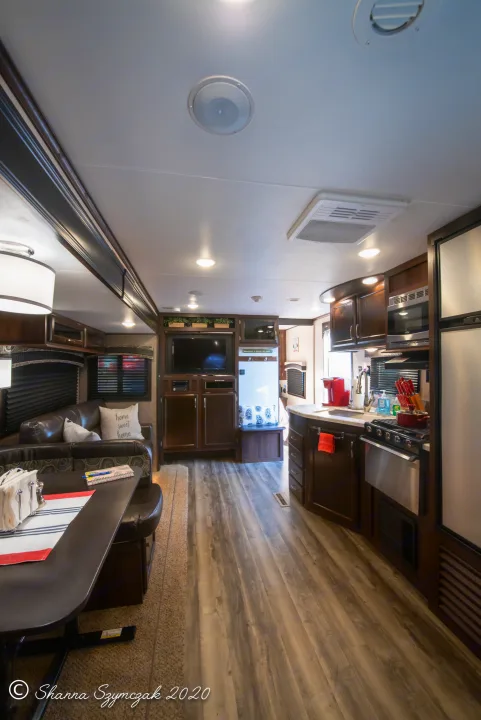 Modern RV rental interior with a fully equipped kitchen, dining area, and cozy seating.. Jayco Bunkhouse 2020