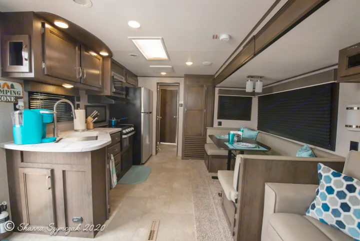 Cozy RV rental interior: a modern kitchen with appliances and a dining booth create a functional living space for your adventures.. Jayco Jay Flight 2020