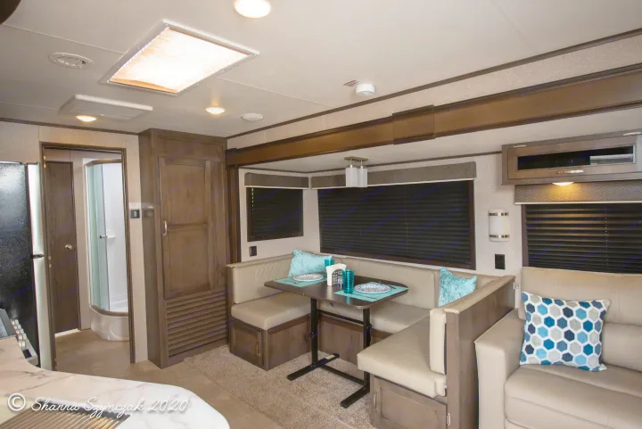 This cozy RV rental interior showcases a dinette, sofa, and visible kitchen & bathroom areas.. Jayco Jay Flight 2020