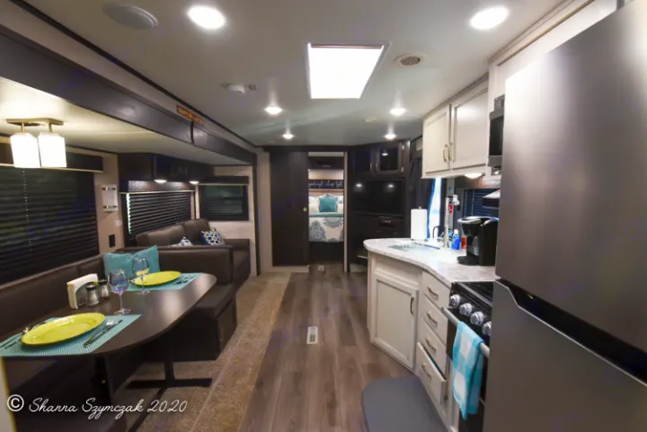 Full interior view of a modern RV rental, showing kitchen, dining, living, and bedroom area.. Jayco Jay Flight 2021