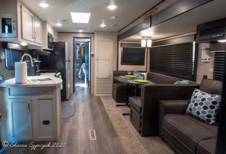 Spacious rv rental interior showing a modern kitchen, dining booth, and cozy living area.. Jayco Jay Flight 2021
