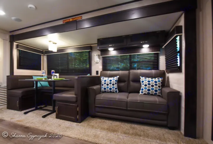 Modern RV rental interior: a spacious living area with sofa and dining booth, perfect for your next camper adventure.. Jayco Jay Flight 2021