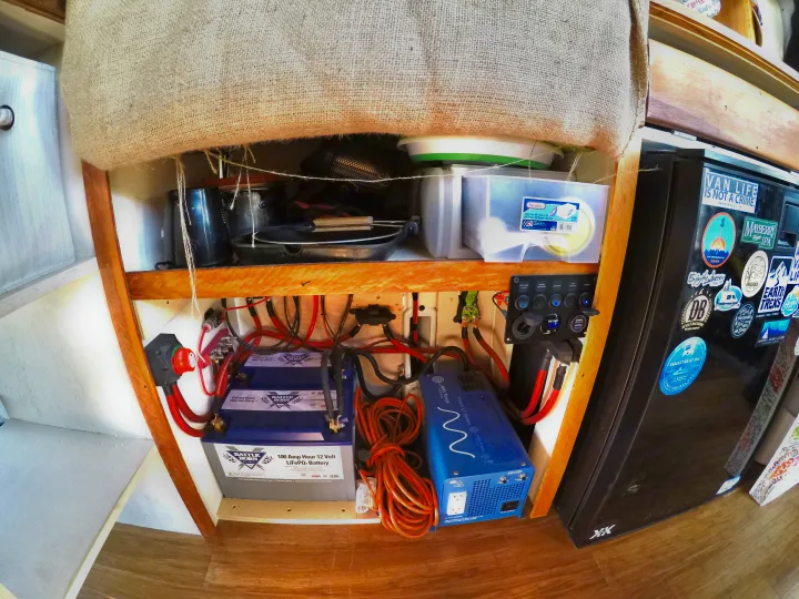 Inside an rv rental: robust Battle Born power system, AIMS inverter, storage for essentials, and a personalized fridge.. Ford Transit 2017