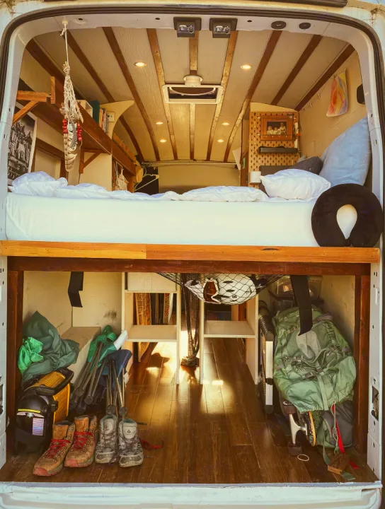 Comfy camper van RV rental interior: raised bed, lower storage for boots/chairs, perfect for adventure.. Ford Transit 2017