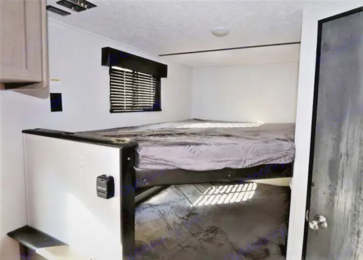 Experience comfort in this rv rental. View of a bunk bed setup with a window, charging port, and natural light.. Keystone Hideout 2021